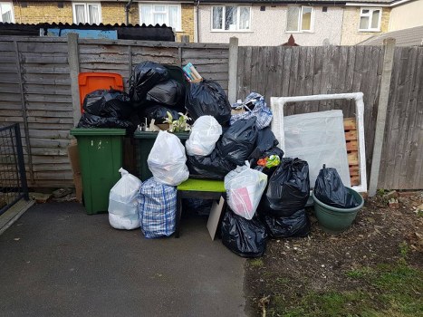 Construction site with organized waste containers in Kings Langley